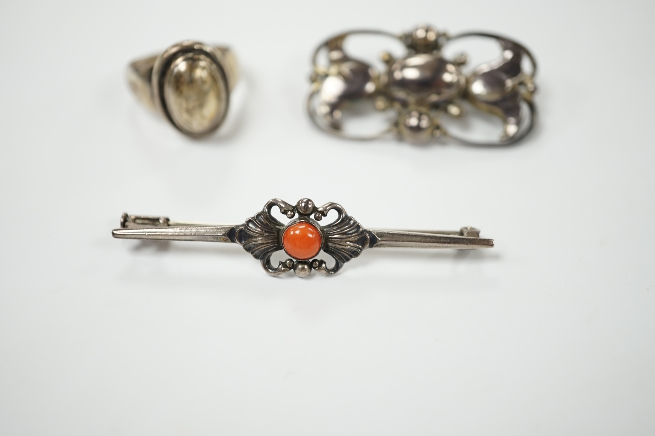 A Georg Jensen sterling and cabochon coral set bar brooch, design no. 214, 53mm, a similar Jensen brooch, design no. 236A, 37mm and a similar ring, design no. 46B, size M. Condition - fair to good